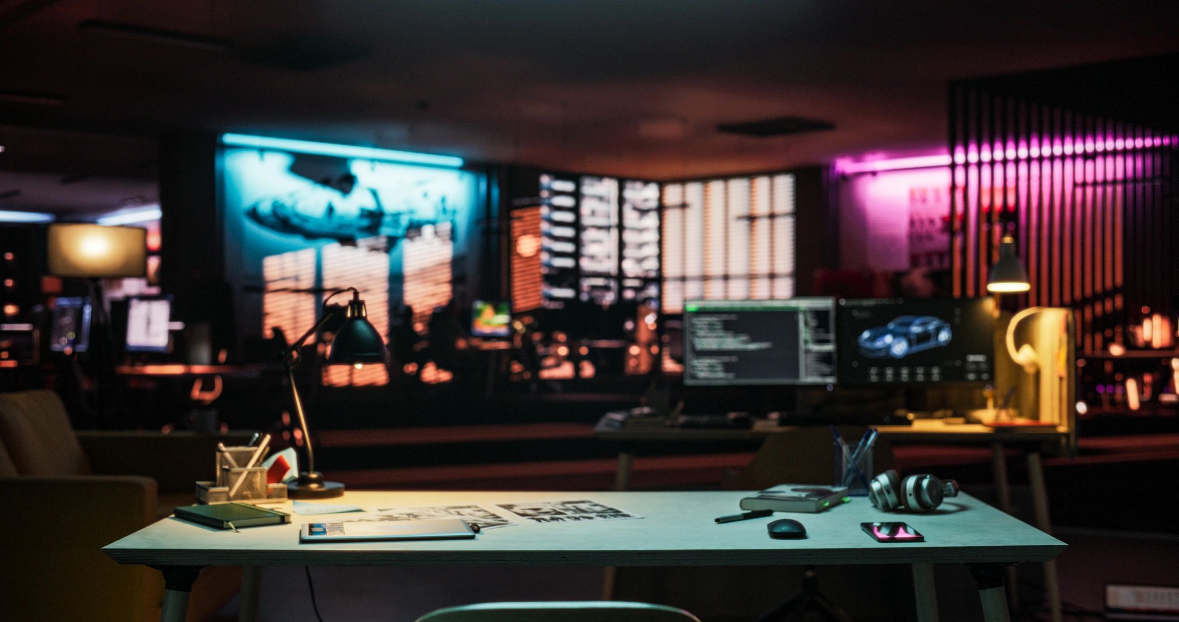 Neon-lit desk setup in a dark tech workspace