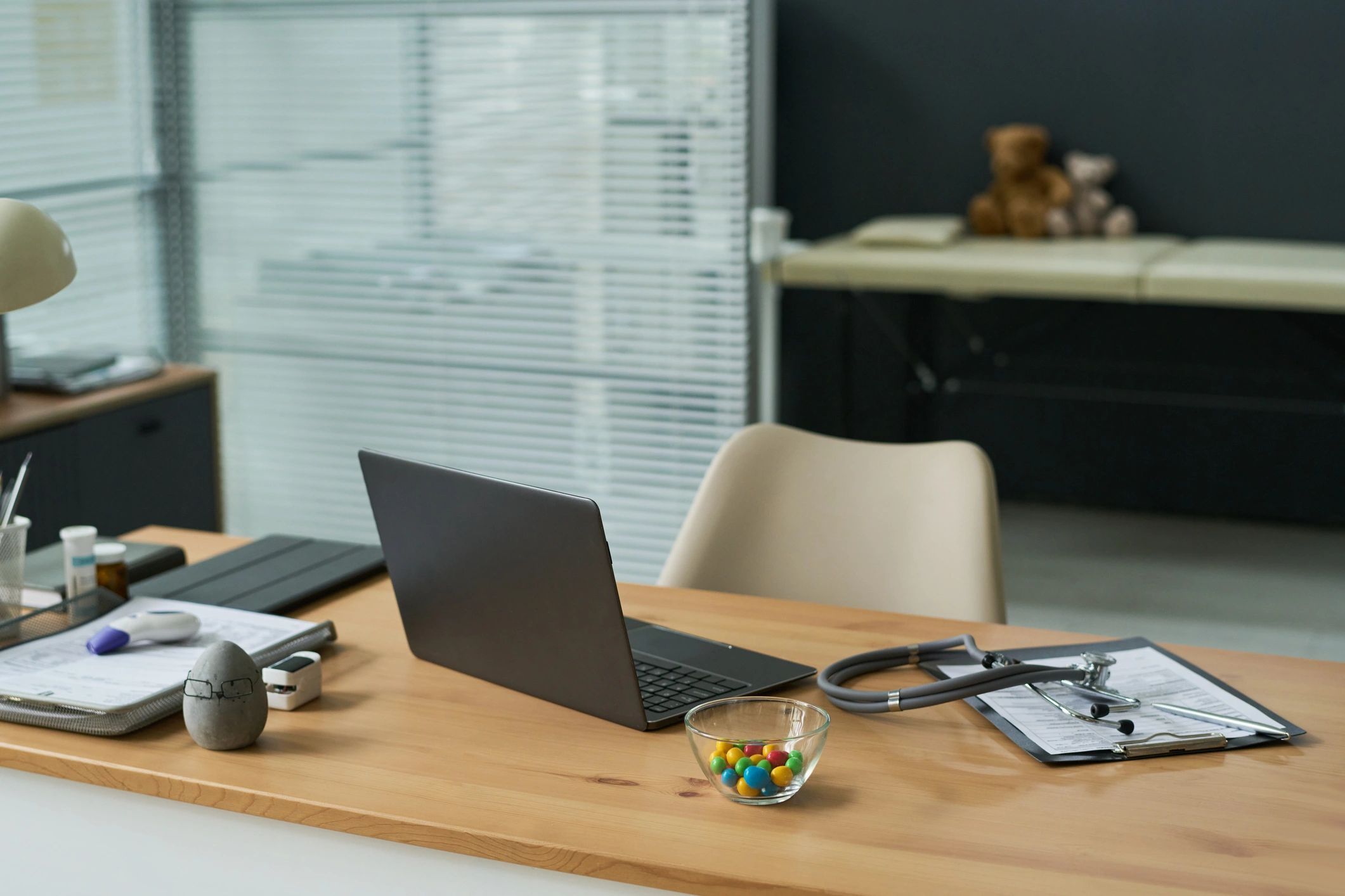 Desk setup with laptop and mobile workflow representing phone reviews